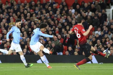 Manchester City's Leroy Sane, center, scores his side's second goal during the English Premier League soccer match between Manchester United and Manchester City at Old Trafford Stadium in Manchester, England, Wednesday April 24, 2019. (AP Photo/Jon Super)
