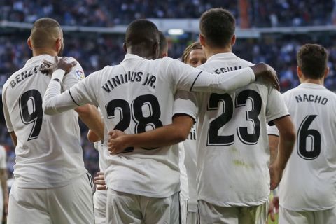 Real Madrid's Vinicius Junior, 2nd left, celebrates with team mates after scoring his side's 1st goal during a Spanish La Liga soccer match between Real Madrid and Valladolid at the Santiago Bernabeu stadium in Madrid, Spain, Saturday, Nov. 3, 2018. (AP Photo/Paul White)