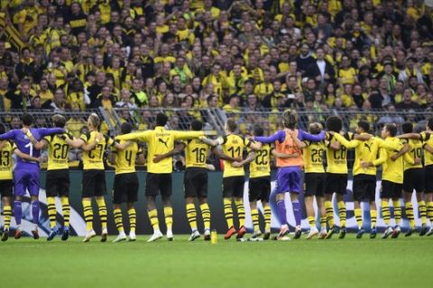 Dortmund's players celebrate with their fans after winning the German Bundesliga soccer match between Borussia Dortmund and RB Leipzig in Dortmund, Germany, Sunday, Aug. 26, 2018. (AP Photo/Martin Meissner)