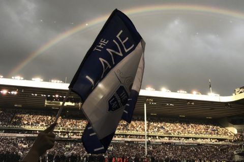 A rainbow appears as fans invade the pitch after the English Premier League soccer match between Tottenham Hotspur and Manchester United at White Hart Lane stadium in London, Sunday, May 14, 2017. It was the last Spurs match at the old stadium, a new stadium is being built on the site. (AP Photo/Rob Harris)