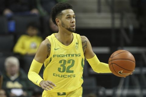 Oregon's Anthony Mathis brings the ball down court against Montana during a college basketball game in Eugene, Ore., Wednesday, Dec. 18, 2019. (AP Photo/Chris Pietsch)