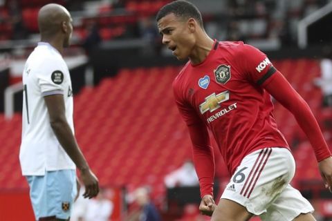 Manchester United's Mason Greenwood celebrates after scoring his side's opening goal during the English Premier League soccer match between Manchester United and West Ham at the Old Trafford stadium in Manchester, England, Wednesday, July 22, 2020. (Cath Ivill/Pool via AP)