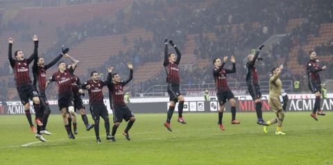 AC Milan players celebrate their 2-1 win over Torino at the end of an Italian Cup, Round of 16 soccer match at the San Siro stadium in Milan, Italy, Thursday, Jan. 12, 2017. (AP Photo/Antonio Calanni)