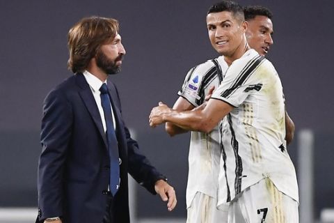 Juventus' coach Andrea Pirlo, left, and Juventus' Cristiano Ronaldo, right, on the field during an Italian Serie A soccer match between Juventus and Sampdoria at the Allianz stadium in Turin, Italy, Sunday, Sept. 20, 2020. (Marco Alpozzi/LaPresse via AP)