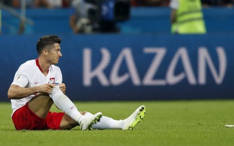 Poland's Robert Lewandowski sits on the pitch during the group H match between Poland and Colombia at the 2018 soccer World Cup at the Kazan Arena in Kazan, Russia, Sunday, June 24, 2018. (AP Photo/Frank Augstein)