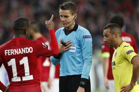 Villarreal's Santi Cazorla, right, looks as Spartak Moscow's Fernando, left, speaks with referee Daniel Siebert of Germany, fights for the ball with Spartak Moscow's Lorenzo Melgarejo, left, and Fernando during the Europa League Group G soccer match between Spartak Moscow and Villarreal at the Otkrytiye Arena stadium in Moscow, Russia, Thursday, Oct. 4, 2018. (AP Photo/Pavel Golovkin)