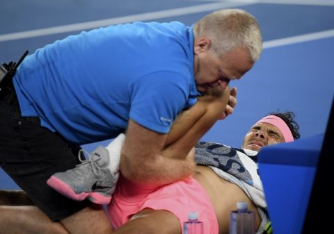 Spain's Rafael Nadal receives treatment from a trainer during his quarterfinal against Croatia's Marin Cilic at the Australian Open tennis championships in Melbourne, Australia, Tuesday, Jan. 23, 2018. (AP Photo/Andy Brownbill)