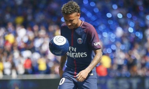 Brazilian soccer star Neymar kicks a ball at the Parc des Princes stadium in Paris, Saturday, Aug. 5, 2017, during his official presentation to fans ahead of Paris Saint-Germain's season opening match against Amiens. Neymar would not play in the club's season opener as the French football league did not receive the player's international transfer certificate before Friday's night deadline. The Brazil star became the most expensive player in soccer history after completing his blockbuster transfer from Barcelona for 222 million euros ($262 million) on Thursday. (AP Photo/Francois Mori)