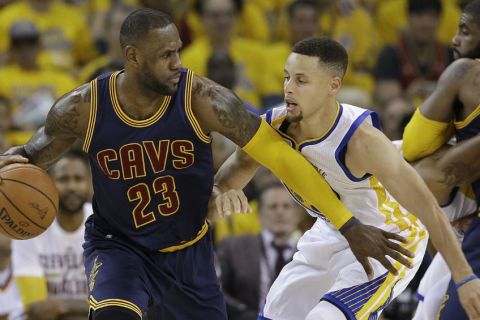 Cleveland Cavaliers forward LeBron James (23) dribbles against Golden State Warriors guard Stephen Curry during the first half of Game 1 of basketball's NBA Finals in Oakland, Calif., Thursday, June 2, 2016. (AP Photo/Marcio Jose Sanchez)