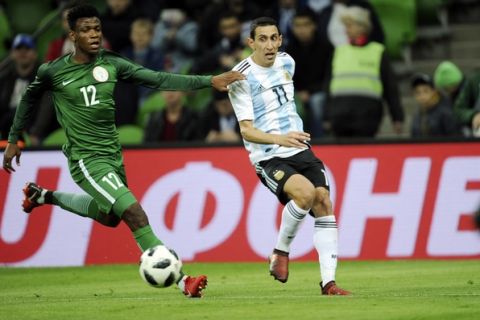 Nigeria's Abdullahi Shehu, left, challenges for the ball with Argentina's Angel Di Maria during the international friendly soccer match between Argentina and Nigeria in Krasnodar, Russia, Tuesday, Nov. 14, 2017. (AP Photo/Sergey Pivovarov)
