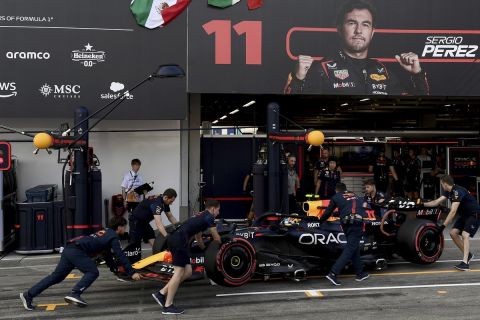 Red Bull driver Sergio Perez of Mexico gets pushed back into his garage during the qualifying session for the Japanese Formula One Grand Prix at the Suzuka Circuit, Suzuka, central Japan, Saturday, Sept. 23, 2023. (Toshifumi Kitamura/Pool via AP)