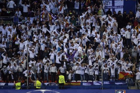 Real Madrid's fans celebrate after they scored their first goal during a Champions League semifinal, 2nd leg soccer match between Atletico de Madrid and Real Madrid, in Madrid, Spain, Wednesday, May 10, 2017 . (AP Photo/Daniel Ochoa de Olza)
