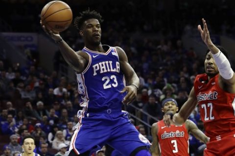 Philadelphia 76ers' Jimmy Butler (23) passes the ball against Washington Wizards' Otto Porter Jr. (22) during the second half of an NBA basketball game, Tuesday, Jan. 8, 2019, in Philadelphia. Philadelphia won 132-115. (AP Photo/Matt Slocum)