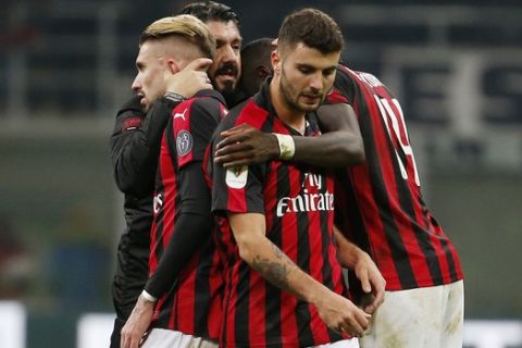 AC Milan coach Gennaro Gattuso, second from left, celebrates with his players after winning an Italian Cup quarter-final soccer match between AC Milan and Napoli at the San Siro stadium, in Milan, Italy, Tuesday, Jan. 29, 2019. (AP Photo/Antonio Calanni)