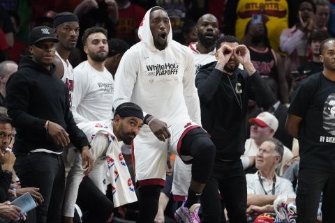 Miami Heat players react on the bench in the final moments of their win over the Atlanta Hawks in an NBA playoff basketball game Sunday, April 24, 2022, in Atlanta. (AP Photo/John Bazemore)