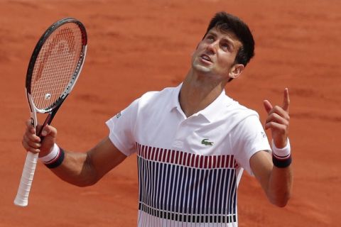 Serbia's Novak Djokovic gestures in the third set of his first round match against Spain's Marcel Granollers at the French Open tennis tournament at the Roland Garros stadium, in Paris, France. Monday, May 29, 2017. (AP Photo/Christophe Ena)