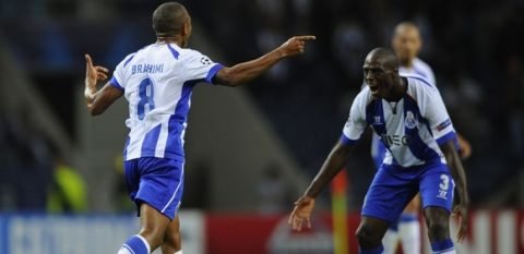 Porto's French-born Algerian midfielder Yacine Brahimi (L) celebrates with his teammate Dutch defender Bruno Martins Indi after scoring his second goal during the UEFA Champions League football match FC Porto vs FC BATE Borisov at the Dragao stadium in Porto on September 17, 2014.   AFP PHOTO / MIGUEL RIOPA        (Photo credit should read MIGUEL RIOPA/AFP/Getty Images)