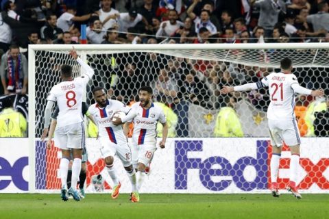 Lyon players celebrate with Lyon's Alexandre Lacazette, second left, after he scored his side's second goal during the second leg semi final soccer match between Olympique Lyon and Ajax in the Stade de Lyon, Decines, France, Thursday, May 11, 2017. (AP Photo/Laurent Cipriani)