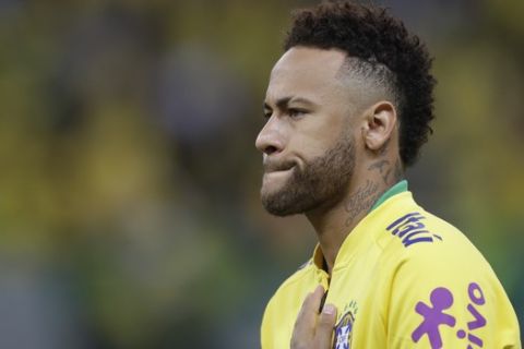Brazil's Neymar puts his hand over his chest during the national anthem, prior a friendly soccer match against Qatar at the Estadio Nacional in Brasilia, Brazil, Wednesday, June 5, 2019.(AP Photo/Andre Penner)
