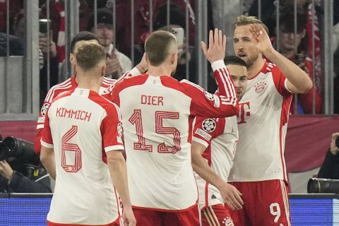 Bayern's Harry Kane, right, celebrates with his teammates after scoring his side's opening goal during the Champions League round of 16 second leg soccer match between FC Bayern Munich and Lazio at the Allianz Arena stadium in Munich, Germany, Tuesday, March 5, 2024. (AP Photo/Matthias Schrader)