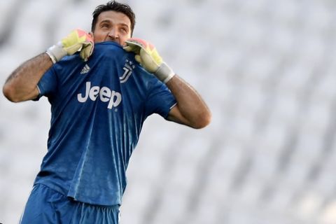 Juventus goalie Gianluigi Buffon reacts during the Serie A soccer match between Juventus and Torino, at the Allianz Stadium in Turin, Italy, Saturday, July 4, 2020. Juventus goalkeeper Gianluigi Buffon set an outright Serie A record on Saturday with his 648th appearance in Italys top flight. The Turin derby game against Torino moved the 42-year-old Buffon one ahead of AC Milan great Paolo Maldini, who set the record in 2009. (Fabio Ferrari/LaPresse via AP)