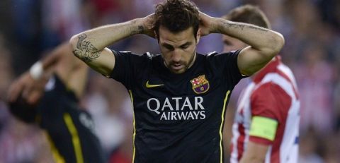 Barcelona's midfielder Cesc Fabregas places his hands on his head during the UEFA Champions League quarter final football match Club Atletico de Madrid vs Barcelona at the Vicente Calderon stadium in Madrid on April 9, 2014. AFP PHOTO / DANI POZO        (Photo credit should read DANI POZO/AFP/Getty Images)