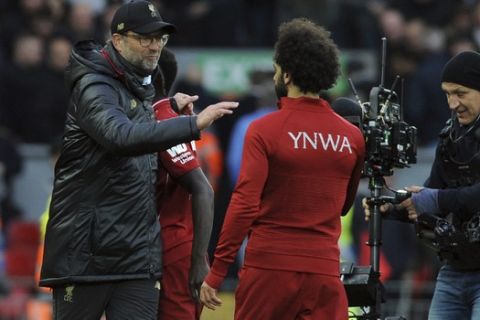 Liverpool manager Juergen Klopp, left, celebrates with Liverpool's Mohamed Salah at the end of the English Premier League soccer match between Liverpool and Tottenham Hotspur at Anfield stadium in Liverpool, England, Sunday, March 31, 2019. (AP Photo/Rui Vieira)