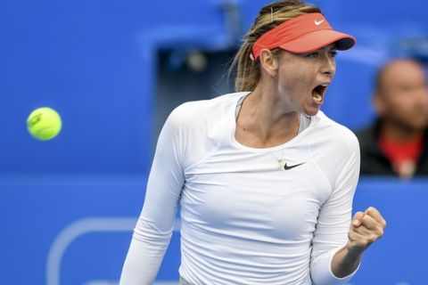 In this photo released by Xinhua News Agency, Maria Sharapova of Russia reacts after scoring a point against opponent Wang Xinyu of China during their match in the Shenzhen Open tennis tournament in Shenzhen, south China's Guangdong Province, Wednesday, Jan. 2, 2019. Sharapova reached the quarterfinals of the Shenzhen Open on Wednesday after Chinese teenager Wang Xinyu retired in the second set with cramps. (Mao Siqian/Xinhua via AP)