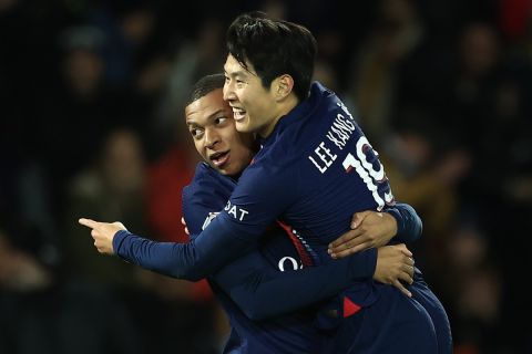 PSG's Lee Kang-in, right, celebrates after scoring the opening goal with Kylian Mbappe during the French League One soccer match between Paris Saint Germain and Montpellier at Parc des Princes stadium in Paris, France, Friday, Oct. 3, 2023. (AP Photo/Aurelien Morissard)