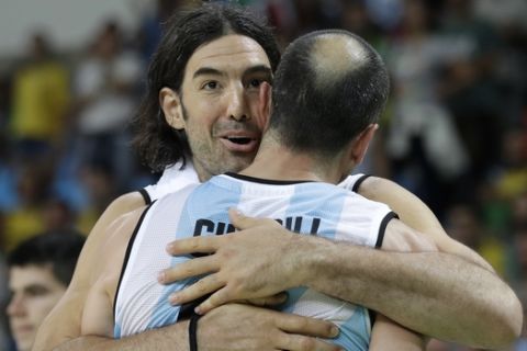 Argentina's Luis Scola, left, hugs teammate Manu Ginobili during a basketball game against Brazil at the 2016 Summer Olympics in Rio de Janeiro, Brazil, Saturday, Aug. 13, 2016. Argentina won 111-107 in double overtime. (AP Photo/Charlie Neibergall)