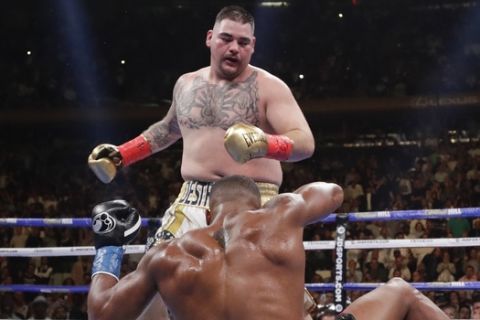 Andy Ruiz knocks down Anthony Joshua during the third round of a heavyweight title boxing match Saturday, June 1, 2019, in New York. Ruiz won in the seventh round. (AP Photo/Frank Franklin II)
