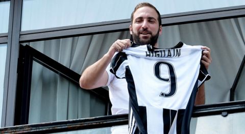 Argentinian striker Gonzalo Higuain shows the Juventus' jersey as he arrives in the team headquarters in Turin, Italy, Wednesday July 27, 2016. Italian champion Juventus said Tuesday it has signed Higuain from Serie A rival Napoli for 90 million euros ($99 million). (Alessandro Di Marco/Ansa via Ap)