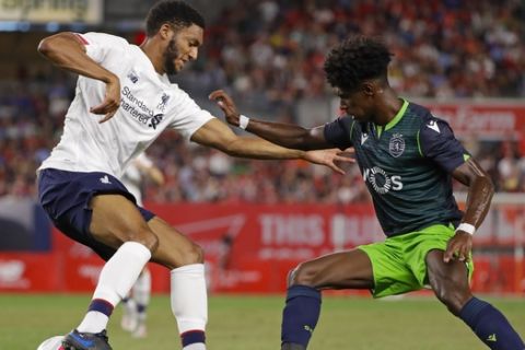 Sporting CP's Thierry Correia, right, fights for control of the ball with Liverpool FC's Joe Gomez during the second half of a soccer match Wednesday, July 24, 2019, in New York. The game ended 2-2. (AP Photo/Frank Franklin II)