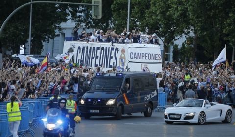 Real Madrid arrive on an open-topped bus to Cibeles square to celebrate after winning the Champions League final, Madrid, Spain, Sunday June 4, 2017. Real Madrid became the first team in the Champions League era to win back-to-back titles with their 4-1 victory over Juventus in Cardiff Saturday. (AP Photo/Paul White)