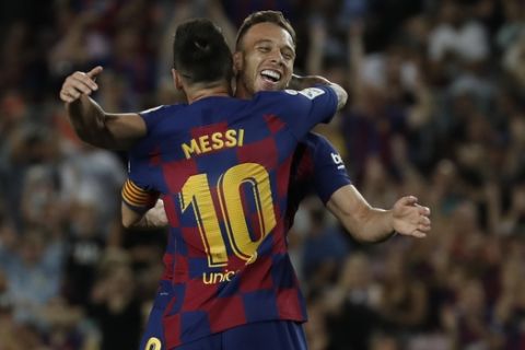 Barcelona's Arthur, right, celebrates with Lionel Messi after scoring his side's second goal during the Spanish La Liga soccer match between FC Barcelona and Villarreal CF at the Camp Nou stadium in Barcelona, Spain, Tuesday, Sep. 24, 2019. (AP Photo/Joan Monfort)