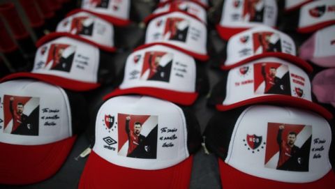 Caps depicting Lionel Messi with a message that reads in Spanish: "Your dream is our illusion," are displayed for sale on the route of a caravan organized by Newell's Old Boys soccer club in Messi's hometown, in Rosario, Argentina, Thursday, Aug. 27, 2020. Fans hope to lure him home following his announcement that he wants to leave Barcelona F.C. after nearly two decades with the Spanish club. (AP Photo/Natacha Pisarenko)