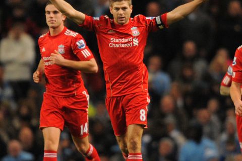 Liverpool's English midfielder Steven Gerrard (R) celebrates after scoring the opening goal during the League cup semi final first leg football match between Manchester City and Liverpool at The Etihad stadium in Manchester, north-west England on January 11, 2012.   AFP PHOTO/ ANDREW YATES

RESTRICTED TO EDITORIAL USE. No use with unauthorized audio, video, data, fixture lists, club/league logos or live services. Online in-match use limited to 45 images, no video emulation. No use in betting, games or single club/league/player publications. (Photo credit should read ANDREW YATES/AFP/Getty Images)