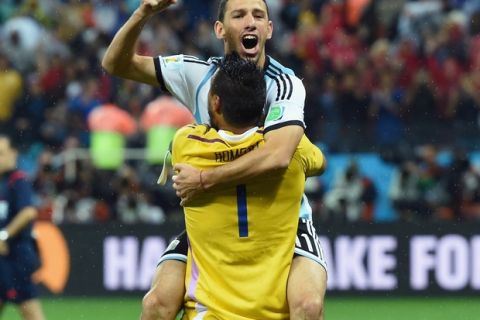 SAO PAULO, BRAZIL - JULY 09:  Maxi Rodriguez of Argentina celebrates with goalkeeper Sergio Romero after making his penalty kick to defeat the Netherlands in a shootout during the 2014 FIFA World Cup Brazil Semi Final match between the Netherlands and Argentina at Arena de Sao Paulo on July 9, 2014 in Sao Paulo, Brazil.  (Photo by Matthias Hangst/Getty Images)