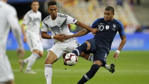 France's Kylian Mbappe, right, challenges for the ball with Germany's Thilo Kehrer during a UEFA Nations League soccer match between France and Germany at Stade de France stadium in Saint Denis, north of Paris, Tuesday, Oct. 16, 2018. (AP Photo/Christophe Ena)