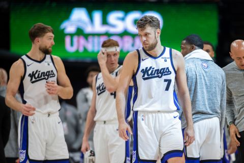 Sacramento Kings forward Sasha Vezenkov (7) waits with teammates during a timeout in the second half in an NBA basketball game against the Cleveland Cavaliers in Sacramento, Calif., Monday, Nov. 13, 2023. The Kings won 132-120. (AP Photo/José Luis Villegas)