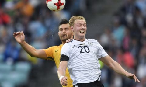 Germany's Julian Brandt, right, and Australia's Bailey Wright go for a header during the Confederations Cup, Group B soccer match between Australia and Germany, at the Fisht Stadium in Sochi, Russia, Monday, June 19, 2017. (AP Photo/Martin Meissner)