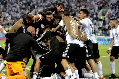 Argentina players celebrates his side's second goal by Argentina's Marcos Rojo during the group D match between Argentina and Nigeria at the 2018 soccer World Cup in the St. Petersburg Stadium in St. Petersburg, Russia, Tuesday, June 26, 2018. (AP Photo/Dmitri Lovetsky)
