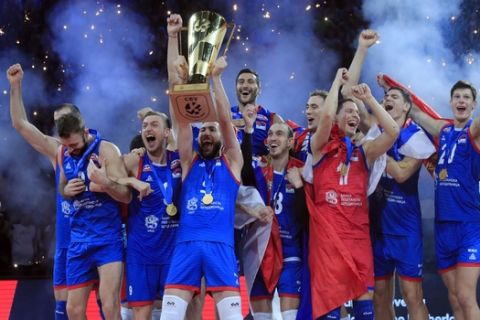 Serbian players celebrate with the trophy after winning a European Volleyball Championship final match between Serbia and Slovenia at the AccorHotels Arena in Paris, Sunday, Sept. 29, 2019. (AP Photo/Michel Euler)