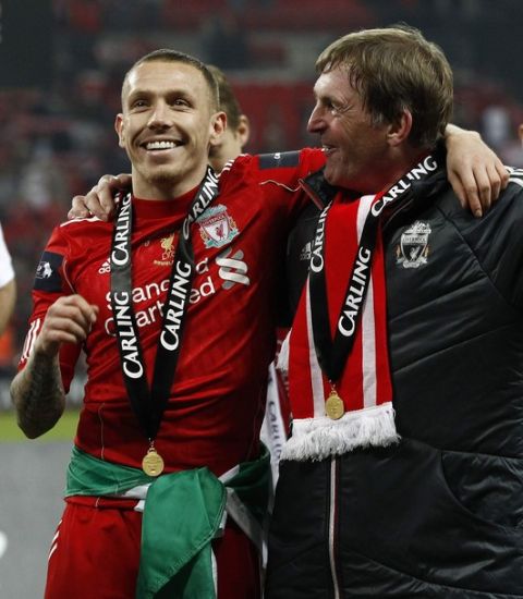 Liverpool's  Craig Bellamy (L) celebrates with coach Kenny Dalglish after their English League Cup final soccer match against Cardiff City at Wembley Stadium in London February 26, 2012. REUTERS/Eddie Keogh (BRITAIN - Tags: SPORT SOCCER CARLING CUP) FOR EDITORIAL USE ONLY. NOT FOR SALE FOR MARKETING OR ADVERTISING CAMPAIGNS. NO USE WITH UNAUTHORIZED AUDIO, VIDEO, DATA, FIXTURE LISTS, CLUB/LEAGUE LOGOS OR "LIVE" SERVICES. ONLINE IN-MATCH USE LIMITED TO 45 IMAGES, NO VIDEO EMULATION. NO USE IN BETTING, GAMES OR SINGLE CLUB/LEAGUE/PLAYER PUBLICATIONS