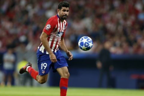 Atletico forward Diego Costa eyes the ball during a Group A Champions League soccer match between Atletico Madrid and Club Brugge at the Wanda Metropolitano stadium in Madrid, Spain, Wednesday Oct. 3, 2018. (AP Photo/Paul White)
