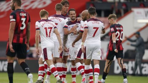 Southampton's Danny Ings, center, celebrates with teammates after scoring his side's opening goal during the English Premier League soccer match between Bournemouth and Southampton at Vitality Stadium in Bournemouth, England, Sunday, July 19, 2020.. (Will Oliver/Pool Photo via AP)
