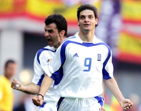 Greece's forward Angelos Charisteas (R) celebrates with his teammate, defender Traianos Dellas after scoring the equaliser goal, 16 June 2004 at Bessa stadium in Porto, during their Euro 2004 group A football match against Spain at the European Nations championship in Portugal. AFP PHOTO Javier SORIANO
