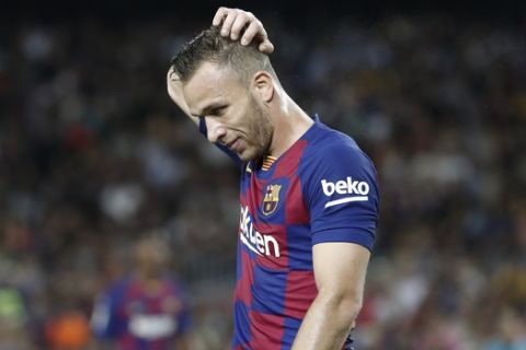 Barcelona's Arthur touches his head during the Spanish La Liga soccer match between FC Barcelona and Villarreal CF at the Camp Nou stadium in Barcelona, Spain, Tuesday, Sep. 24, 2019. (AP Photo/Joan Monfort)