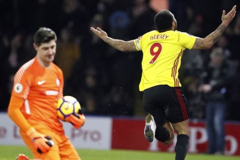 Watford's Troy Deeney celebrates after scoring his side's first goal against Chelsea's goalkeeper Thibaut Courtois, left, during the English Premier League soccer match between Watford and Chelsea at Vicarage Road stadium in London, Monday, Feb. 5, 2018.(AP Photo/Frank Augstein)