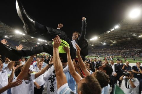 Lazio coach Simone Inzaghi is cheered by his players at the end of the Italian Super Cup final match between Lazio and Juventus at Rome's Olympic stadium, Sunday, Aug. 13, 2017. Lazio won 3-2. (AP Photo/Gregorio Borgia)